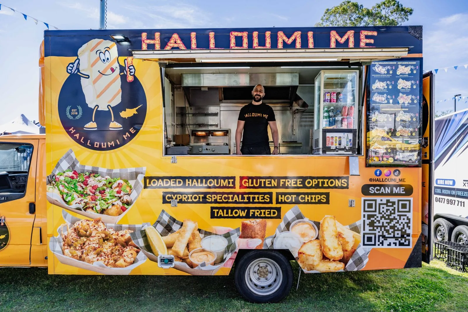 The orange Halloumi Me food truck with Tony at the serving window